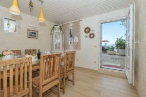 a kitchen with a table and chairs and a window at House Katarina in Krvavica