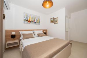 a bedroom with a large bed in a room at House Katarina in Krvavica +28 photos