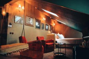 a room with a bed and a couch and chairs at Pensão Amor Madam's Lodge in Lisbon
