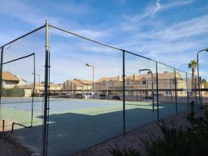 a tennis court with a net on a tennis court at 2bed 1 bath condo near Nellis afb & the strip in Las Vegas