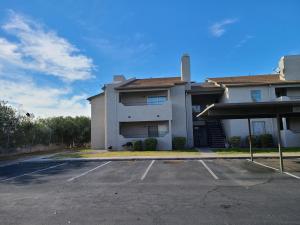 a parking lot in front of a house at 2bed 1 bath condo near Nellis afb & the strip in Las Vegas