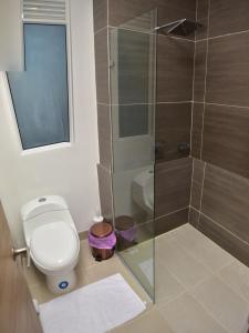 a bathroom with a toilet and a glass shower at Luxury Aparment in Reserva del Mar in Gaira