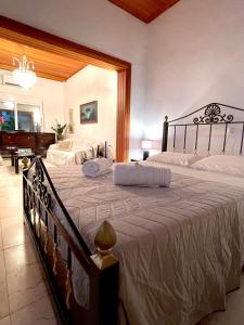 a bedroom with a large bed and a piano at Emerald Apartment in Spata