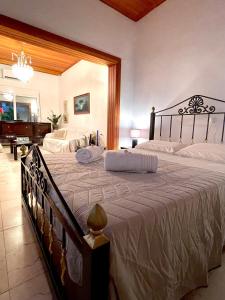 a bedroom with a large bed and a piano at Emerald Luxury Apartments - ATH Airport in Spata