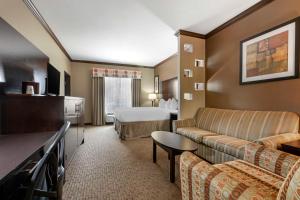 a hotel room with a couch and a bed at Best Western Plus Texoma Hotel & Suites in Denison