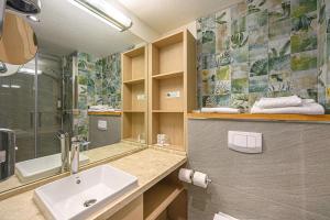 a bathroom with a sink and a shower at Best Western Plus H&ocirc;tel Vannes Centre Ville in Vannes