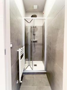 a shower with a glass door in a bathroom at BLUE HOUSE - incantevole casa a due passi dal mare in Grottammare
