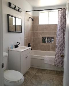 a bathroom with a tub and a toilet and a sink at Panoramic Lake View, Lake Isabella in Wofford Heights