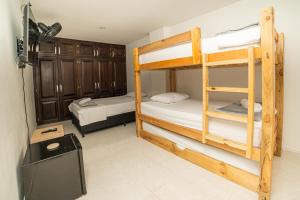 a room with two bunk beds and a tv at Estancia Única en Medellín Habitación Privada B in Medellín