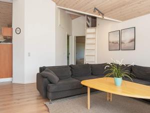 a living room with a couch and a table at 6 person holiday home in Hemmet in Falen