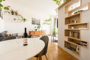 a living room with a white table and two wine glasses at Dohany Design Apartments in Budapest