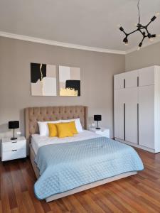 a bedroom with a bed and two night stands at SOPRANO APARTMENT KRAKIVSKA 34 in Lviv