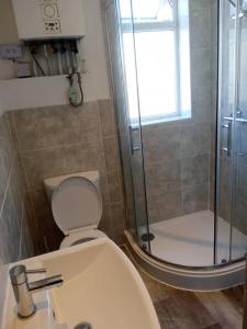 a bathroom with a toilet and a glass shower at Double-bed (G4) close to Burnley city centre in Burnley