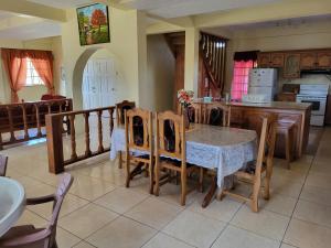 a kitchen and dining room with a table and chairs at OceanView Villa in Buccoo