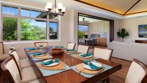a dining room with a table and chairs at MAUNA KEA SUNRISE Distinguished 4BR KaMilo Home with Private Beach Pass in Waikoloa