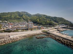 an aerial view of a city and a bridge over the water at Boyokaku in Amakusa
