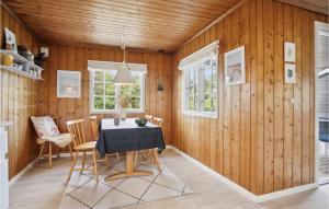 a dining room with wooden walls and a table and chairs at Stunning Home In Fan With 2 Bedrooms And Wifi in Fanø