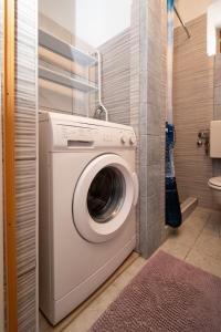 a laundry room with a washing machine in a bathroom at Apartment Preko 8179b in Preko
