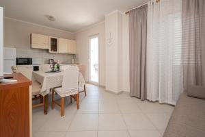 a kitchen and dining room with a table and chairs at Apartment Povljana 6298b in Povljana
