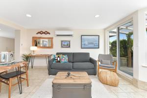 a living room with a couch and a table at Gulf Island View Suite in Chemainus