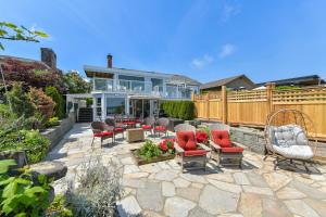a patio with chairs and tables and a fence at Gulf Island View Suite in Chemainus