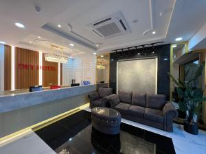 a lobby with a couch and a bar at Dey Hotel Kota Bharu in Kota Bharu