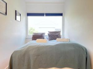 a bedroom with a large bed with a window at One Bedroom Apartment In Valby, Langagervej 64, 2 in Copenhagen