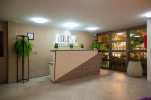 a restaurant lobby with a sign that reads bliss brighter proof at BLISS BOUTIQUE HOTEL BOGOTA in Bogotá