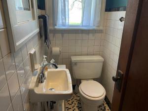 a bathroom with a toilet and a sink at Historic Downtown Brownsburg Home w/Charm in Brownsburg