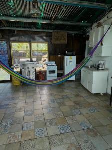 a room with a hammock in the middle of a kitchen at Cabaña Cielo y Luna in Planes de Renderos