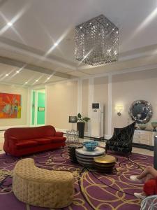 a living room with a red couch and a rug at Lovely & Stylish 1BR in Mckinley Hill with View in Manila
