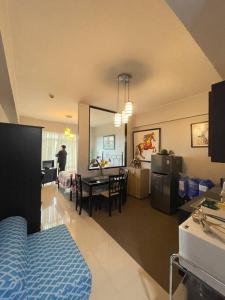 a living room with a kitchen and a dining room at Lovely & Stylish 1BR in Mckinley Hill with View in Manila