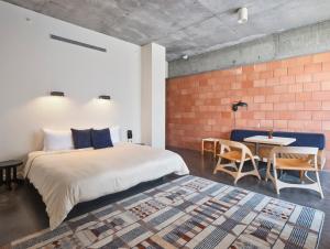 a bedroom with a large bed and a table at The Carpenter Hotel in Austin