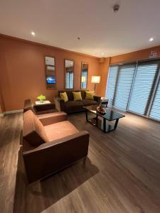 a living room with a couch and a table at City Park Hotel Residences in Manila