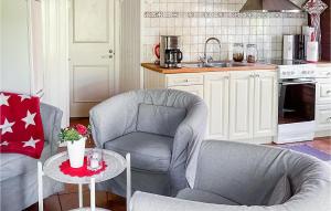 a kitchen with two chairs and a table at Stunning Home In Vstervik With Kitchen in Västervik