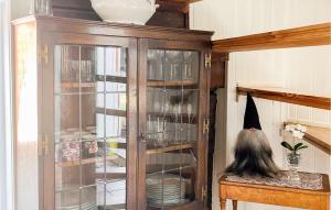 a cabinet with a witch hat sitting on a table at Stunning Home In Vstervik With Kitchen in Västervik