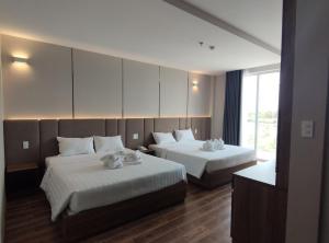 Postel nebo postele na pokoji v ubytování HO TRAM GOLDEN HOTEL