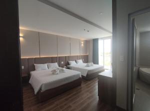 Postel nebo postele na pokoji v ubytování HO TRAM GOLDEN HOTEL