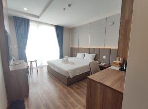 Postel nebo postele na pokoji v ubytování HO TRAM GOLDEN HOTEL
