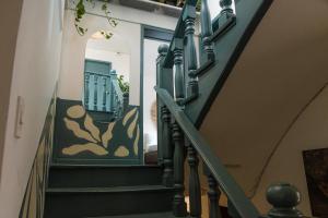 a staircase in a house with green railings at Trip Monkey Zona G in Bogotá