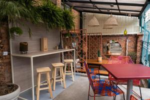 a restaurant with chairs and a table and a counter at Trip Monkey Zona G in Bogotá