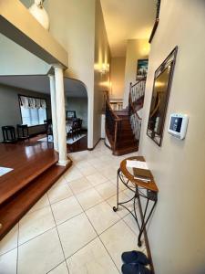 a living room with a staircase and a table at Hotel/Home in Windsor