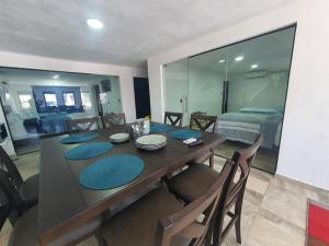 a dining room with a table and chairs and a bedroom at FIESTA MIRAMAR in Ciudad Madero