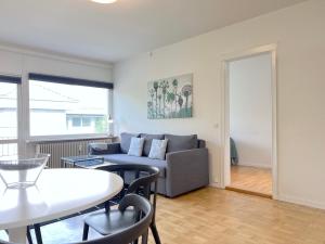 a living room with a couch and a table at One Bedroom Apartment In Valby, Langagervej 64, 2 in Copenhagen