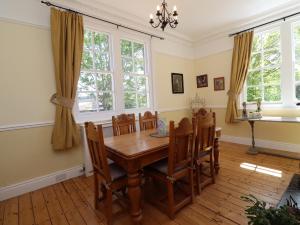 a dining room with a wooden table and chairs at Buzzards Rest in Morpeth