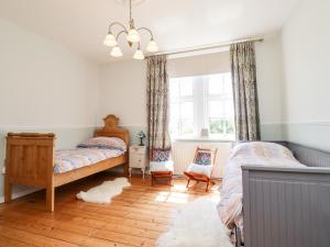 a bedroom with two beds and a window at Buzzards Rest in Morpeth