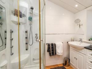 a bathroom with a shower and a sink at Buzzards Rest in Morpeth