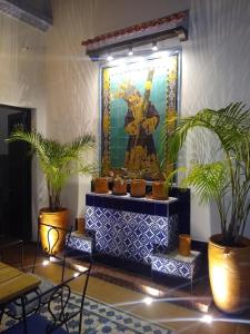 a painting of a god in a room with plants at Villa del Prado in Medellín