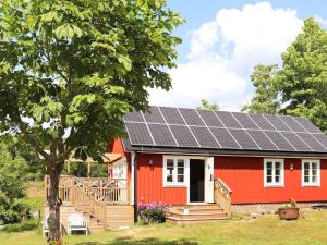 a red house with solar panels on the roof at 4 person holiday home in ROLFSTORP-By Traum in Rolfstorp +17 photos