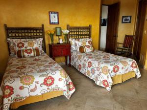 a bedroom with two beds and a table with a chair at Rio Rancho Verde Two Bedroom Suite in Scottsdale +70 photos